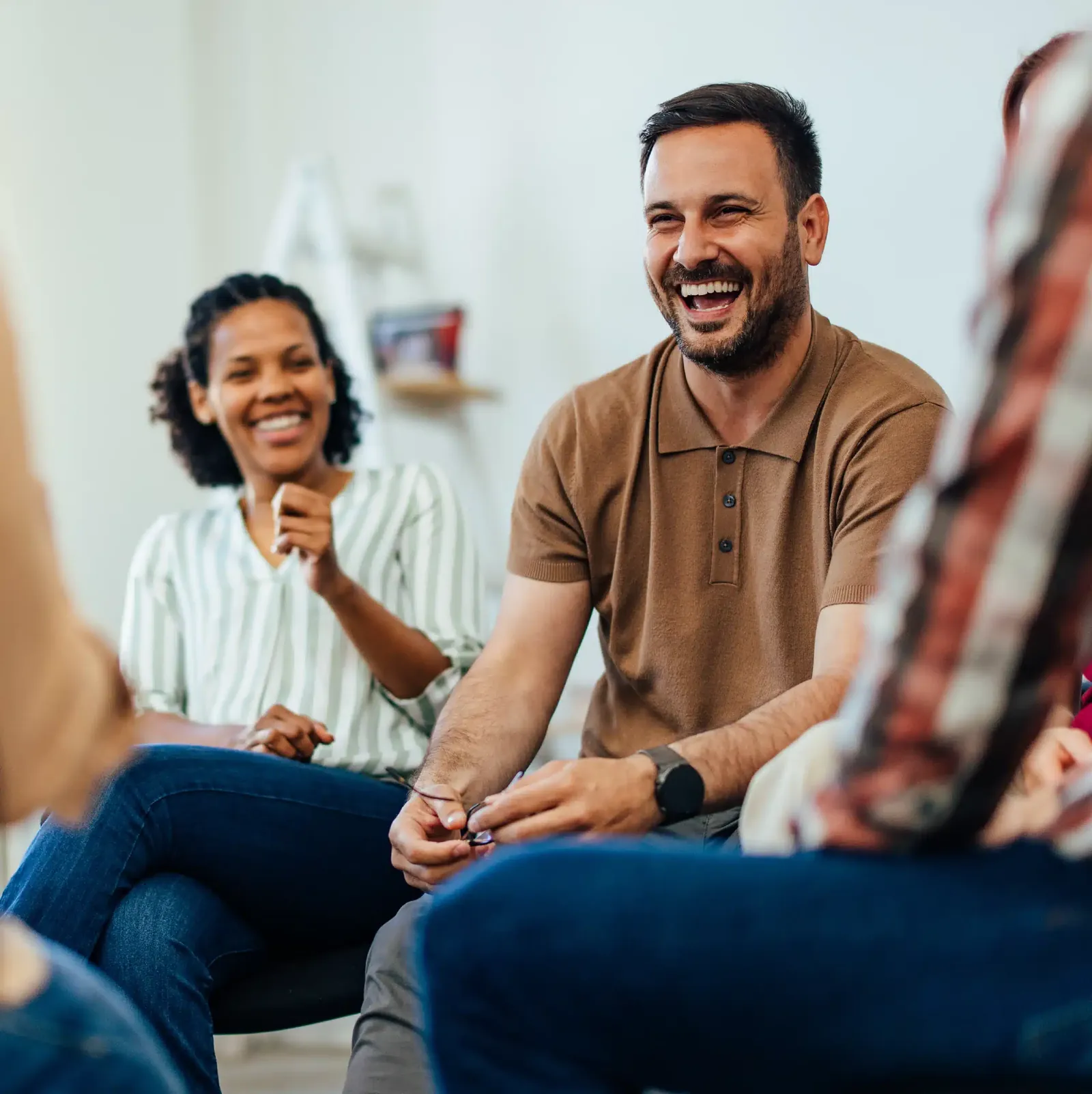 A group therapy session — people talking and laughing together
